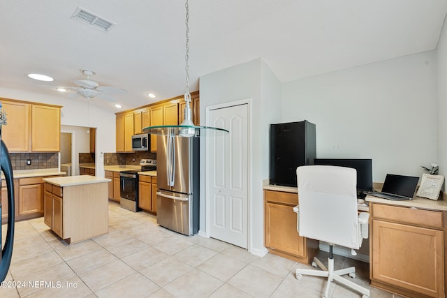 kitchen featuring appliances with stainless steel finishes, backsplash, a kitchen island, ceiling fan, and decorative light fixtures