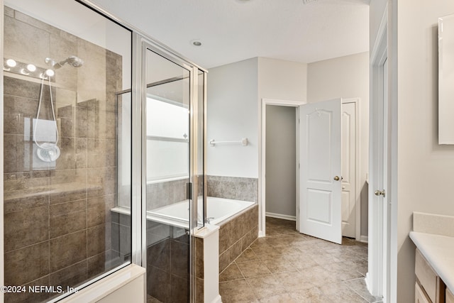 bathroom with plus walk in shower, tile patterned floors, and vanity