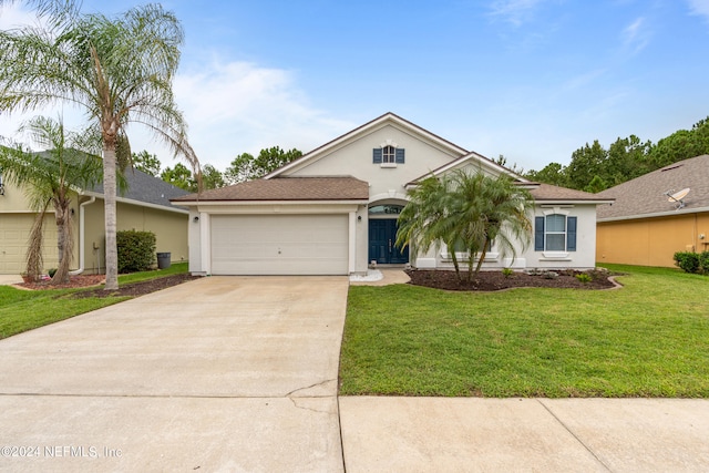 single story home featuring a front lawn and a garage