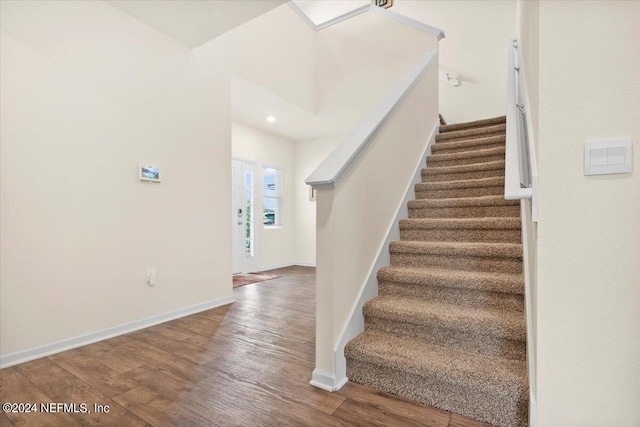 stairway with hardwood / wood-style flooring