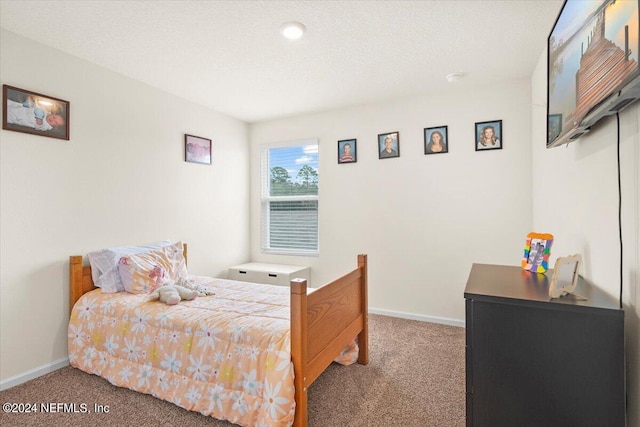 carpeted bedroom with a textured ceiling