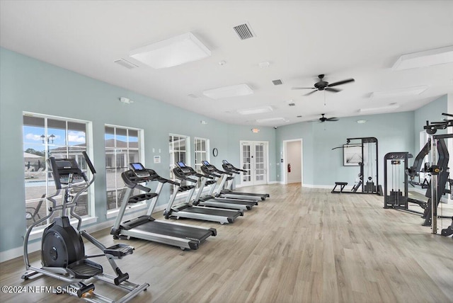 workout area featuring ceiling fan, french doors, and light hardwood / wood-style flooring