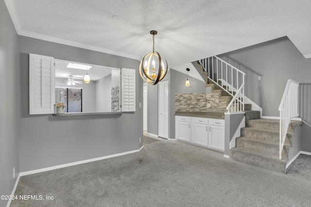 interior space featuring a textured ceiling, carpet flooring, and crown molding