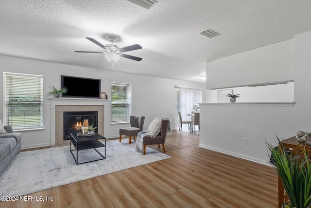 living room with a healthy amount of sunlight, ceiling fan, and hardwood / wood-style flooring