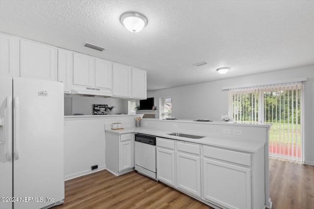 kitchen featuring kitchen peninsula, white appliances, a textured ceiling, white cabinetry, and light hardwood / wood-style floors