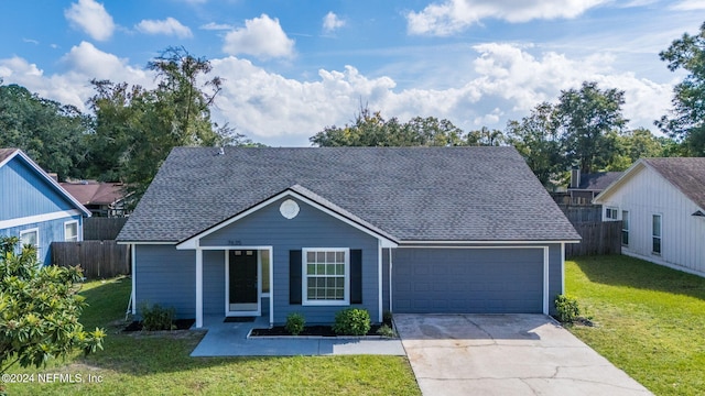 view of front of home featuring a front yard and a garage