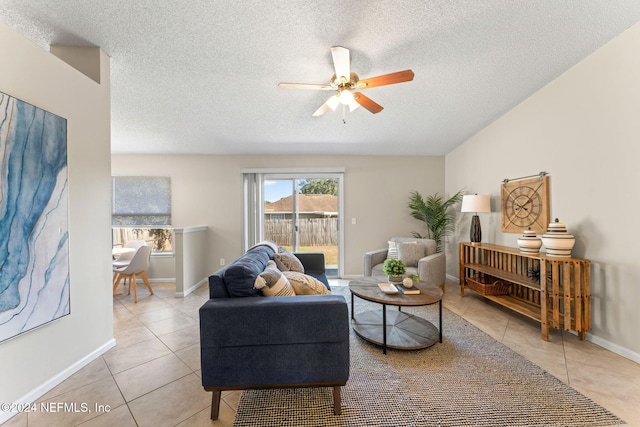 tiled living room with ceiling fan and a textured ceiling