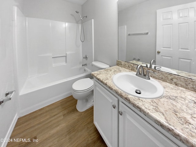 full bathroom featuring vanity, toilet, tub / shower combination, and wood-type flooring