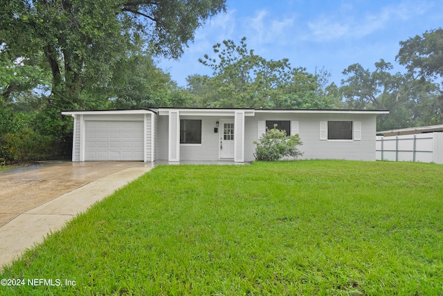 ranch-style house featuring a garage and a front yard