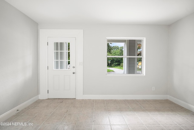 doorway with light tile patterned flooring