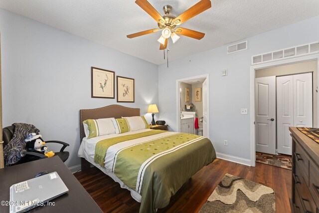 bedroom featuring a closet, a textured ceiling, dark hardwood / wood-style floors, connected bathroom, and ceiling fan