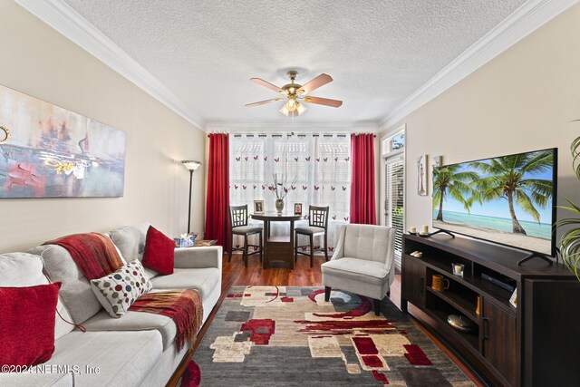 living room with ornamental molding, dark hardwood / wood-style floors, and ceiling fan