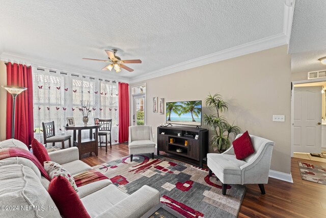 living room with a textured ceiling, crown molding, dark hardwood / wood-style floors, and ceiling fan