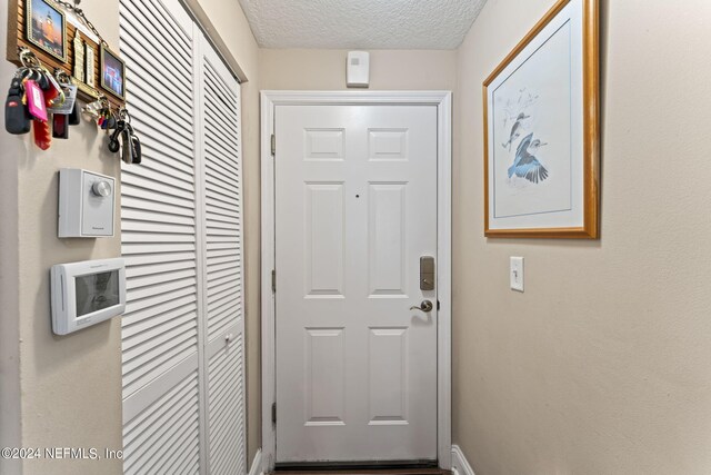 entryway featuring a textured ceiling