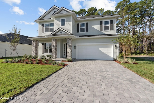 view of front of home featuring a garage and a front lawn