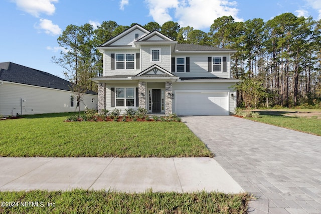 view of front of property featuring a front yard and a garage