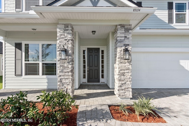 view of exterior entry with a garage