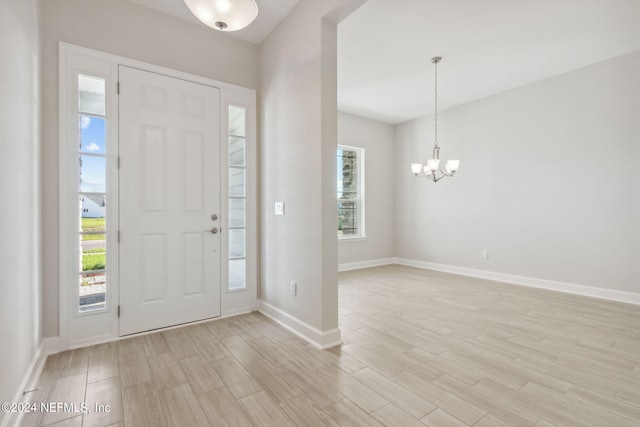 entryway featuring light hardwood / wood-style floors and a chandelier