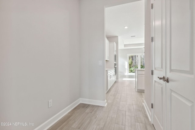 hallway with light hardwood / wood-style flooring