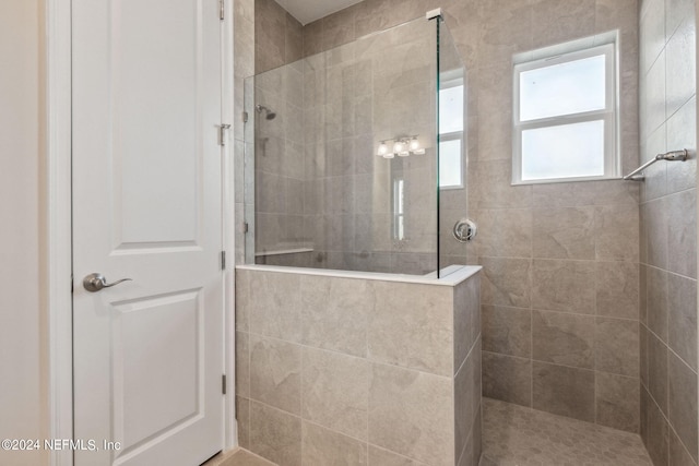 bathroom with a tile shower