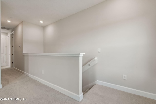 corridor with light colored carpet