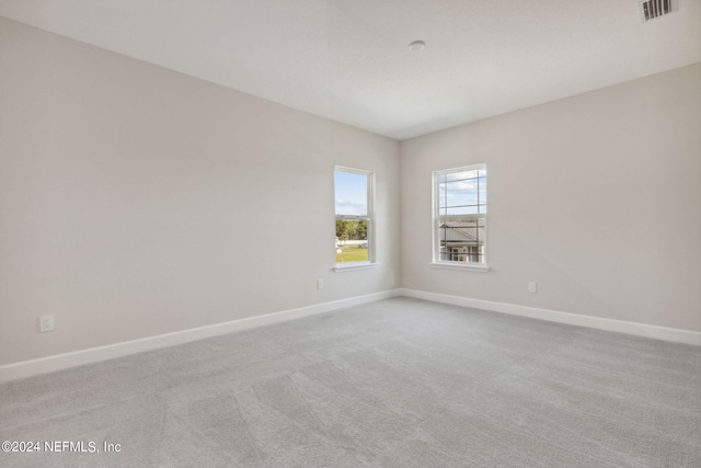 unfurnished room featuring light colored carpet