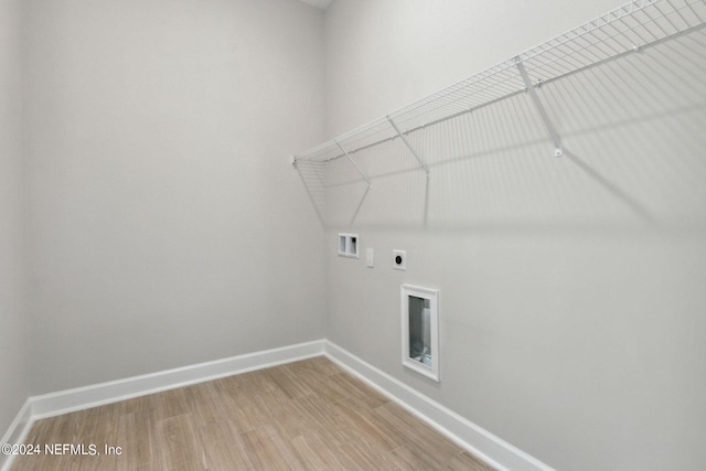 clothes washing area featuring hookup for an electric dryer, washer hookup, and hardwood / wood-style flooring