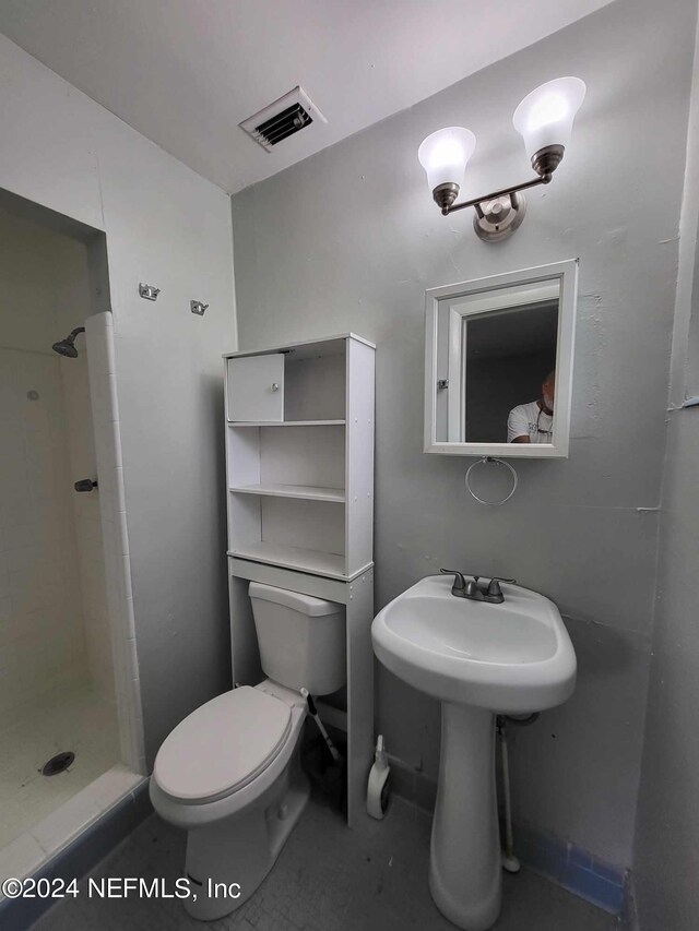 bathroom with a shower and toilet