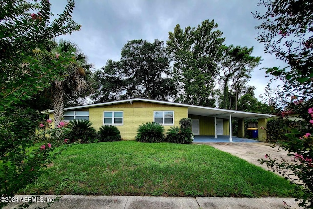 ranch-style home with a carport and a front yard