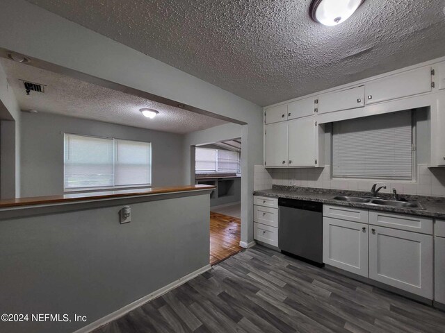 kitchen featuring dark hardwood / wood-style floors, dishwasher, sink, and white cabinets