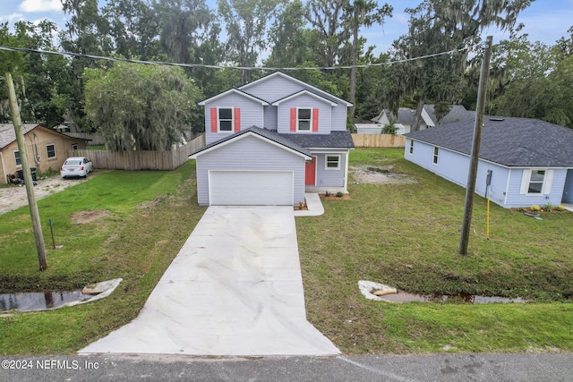 view of front of property featuring a front yard and a garage