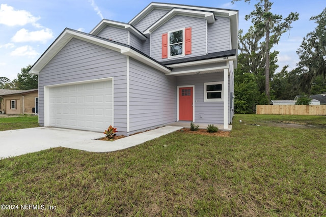 view of front of house with a garage and a front yard