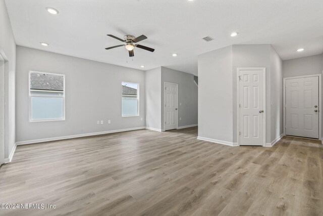 unfurnished room featuring plenty of natural light, ceiling fan, and light hardwood / wood-style floors