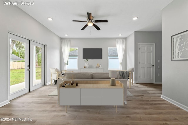 unfurnished bedroom featuring access to exterior, ceiling fan, and light wood-type flooring