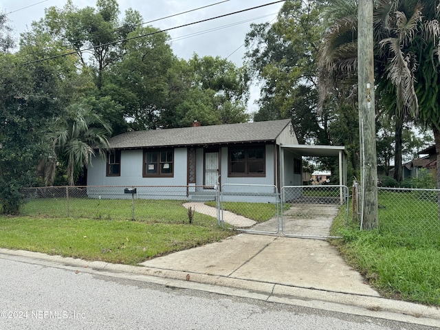 view of front facade featuring a front lawn and a carport