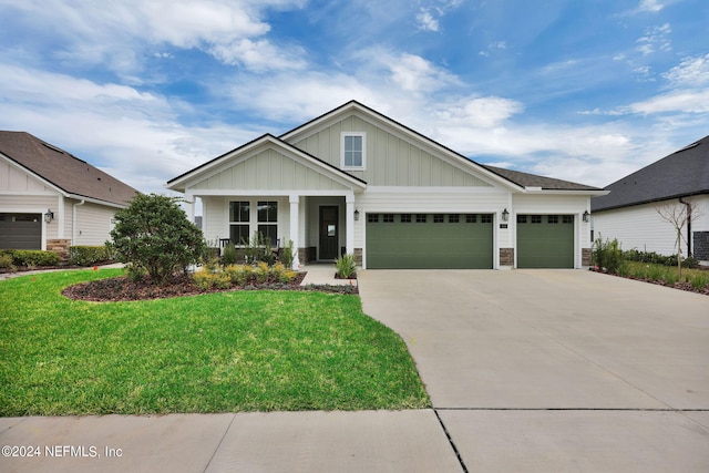 craftsman house with a garage, covered porch, a front lawn, and central AC