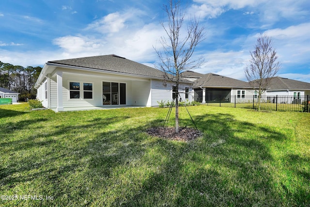 back of house featuring a yard