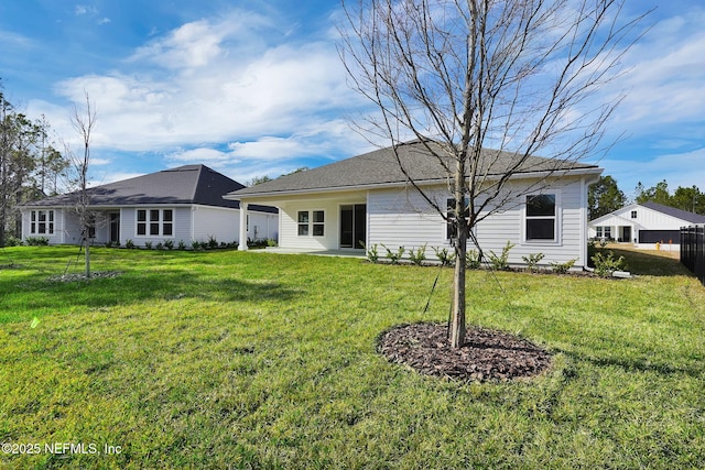 back of property with a lawn and a patio area