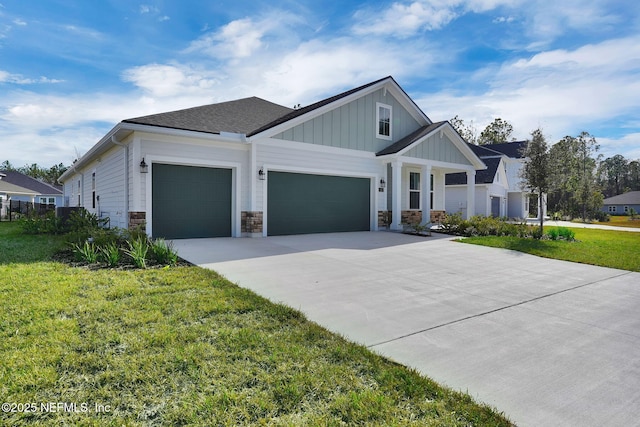 view of front of home with a garage and a front lawn