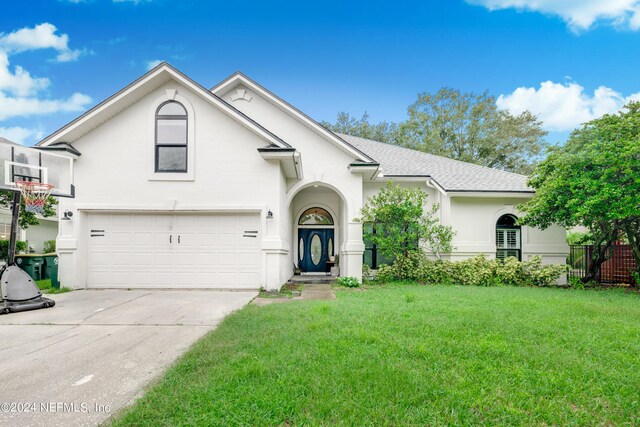 view of front of house with a garage and a front lawn