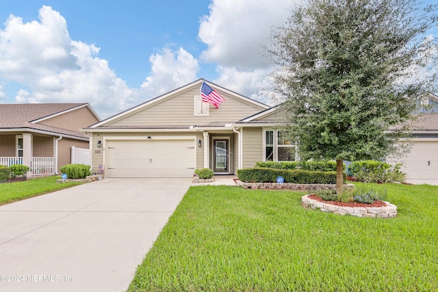 view of front of property with a garage and a front lawn