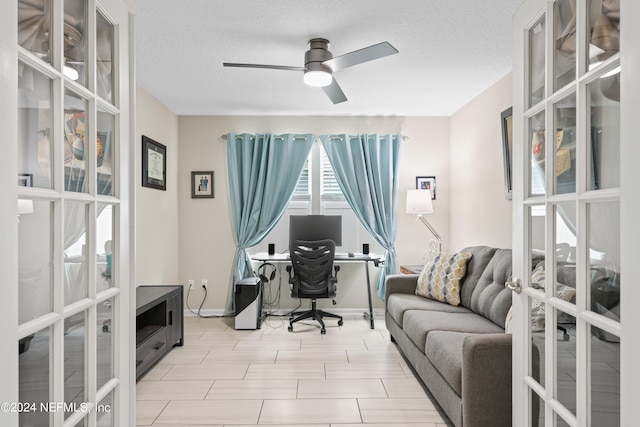 office space featuring ceiling fan and a textured ceiling