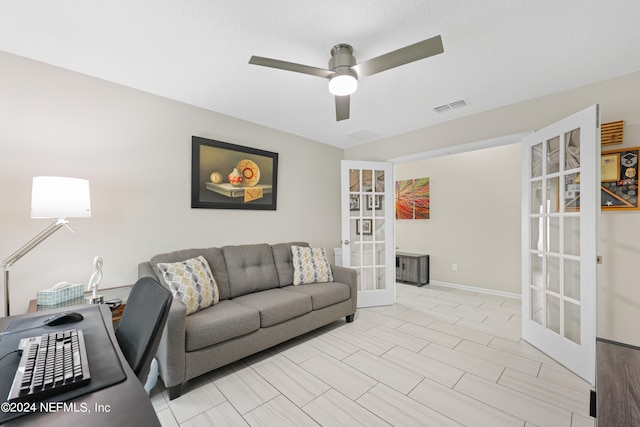 living room with ceiling fan and french doors