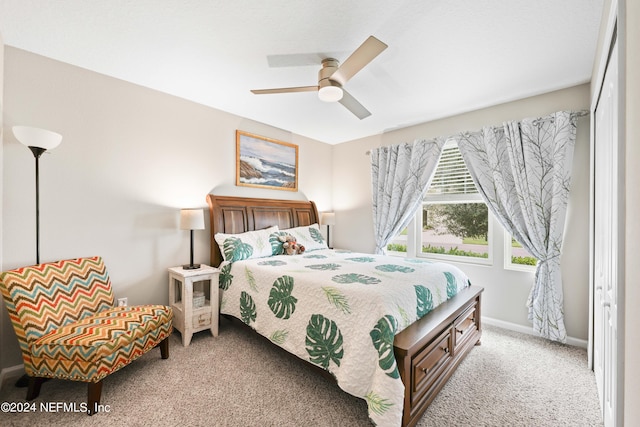 bedroom featuring ceiling fan, light colored carpet, and a closet