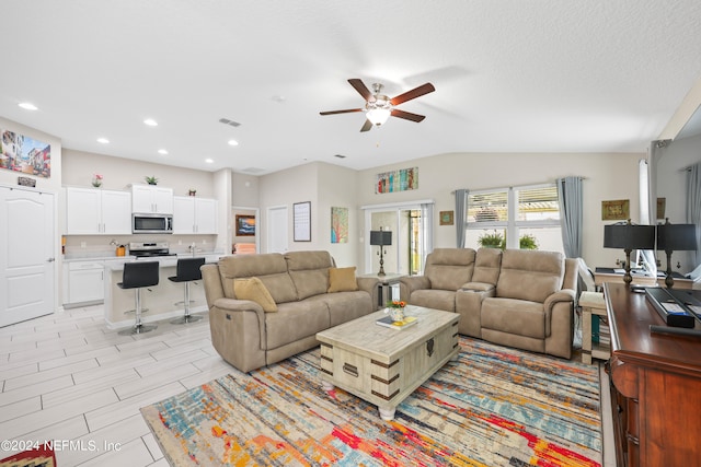 living room with lofted ceiling and ceiling fan