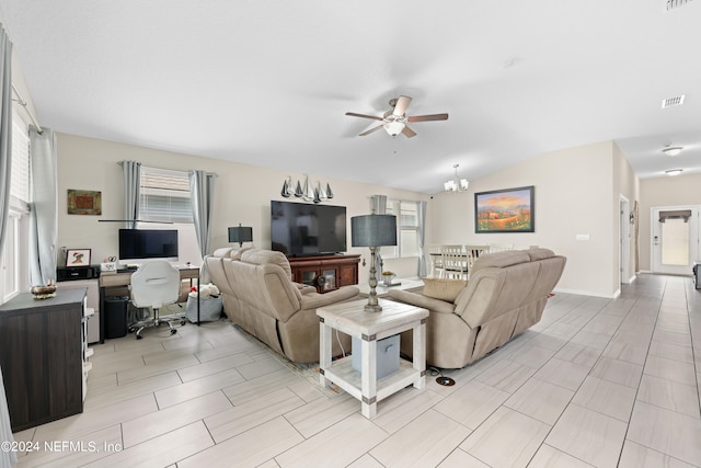 living room with ceiling fan with notable chandelier and vaulted ceiling