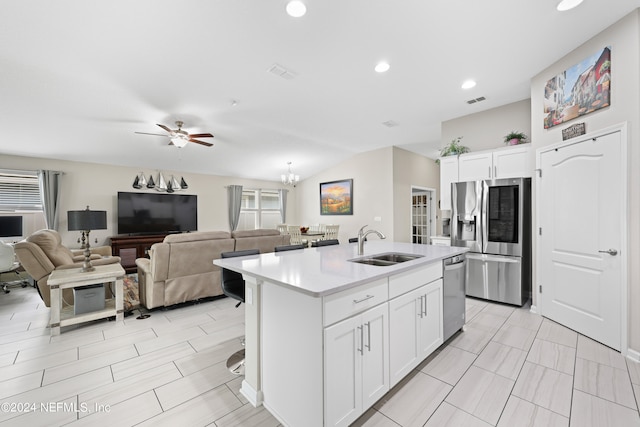 kitchen featuring an island with sink, appliances with stainless steel finishes, sink, and white cabinetry