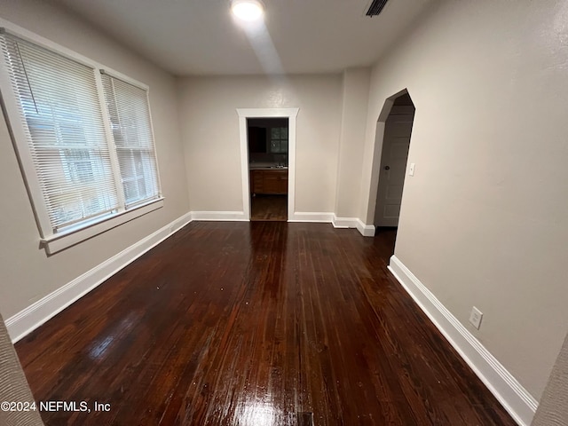 unfurnished room featuring dark hardwood / wood-style flooring