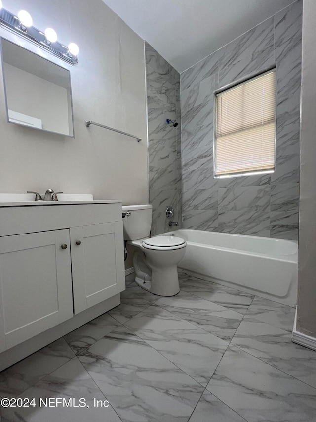 full bathroom featuring tiled shower / bath, toilet, and vanity