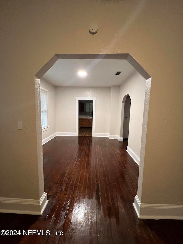 additional living space with dark hardwood / wood-style floors